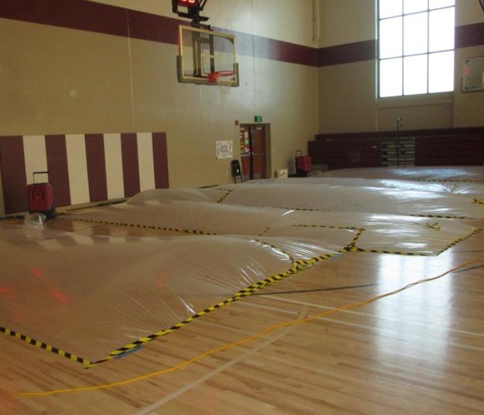 gym floor being dried using safe practices